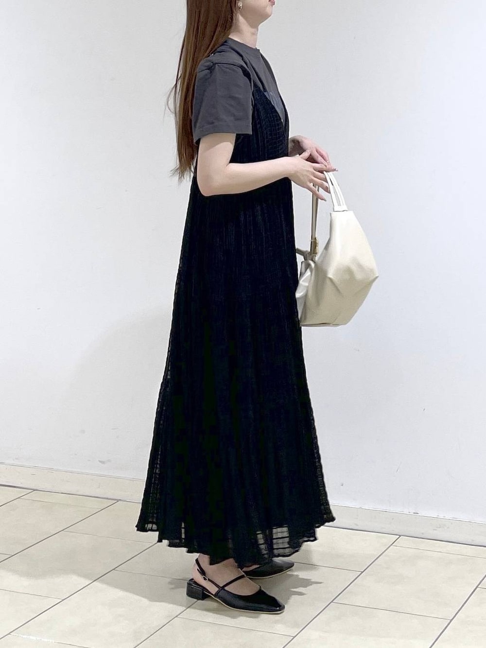 ホワイト系のショルダーバッグ、ブラック系のパンプス、グレー系のTシャツ/カットソーを着用したレディースの春コーディネートの3枚目の写真