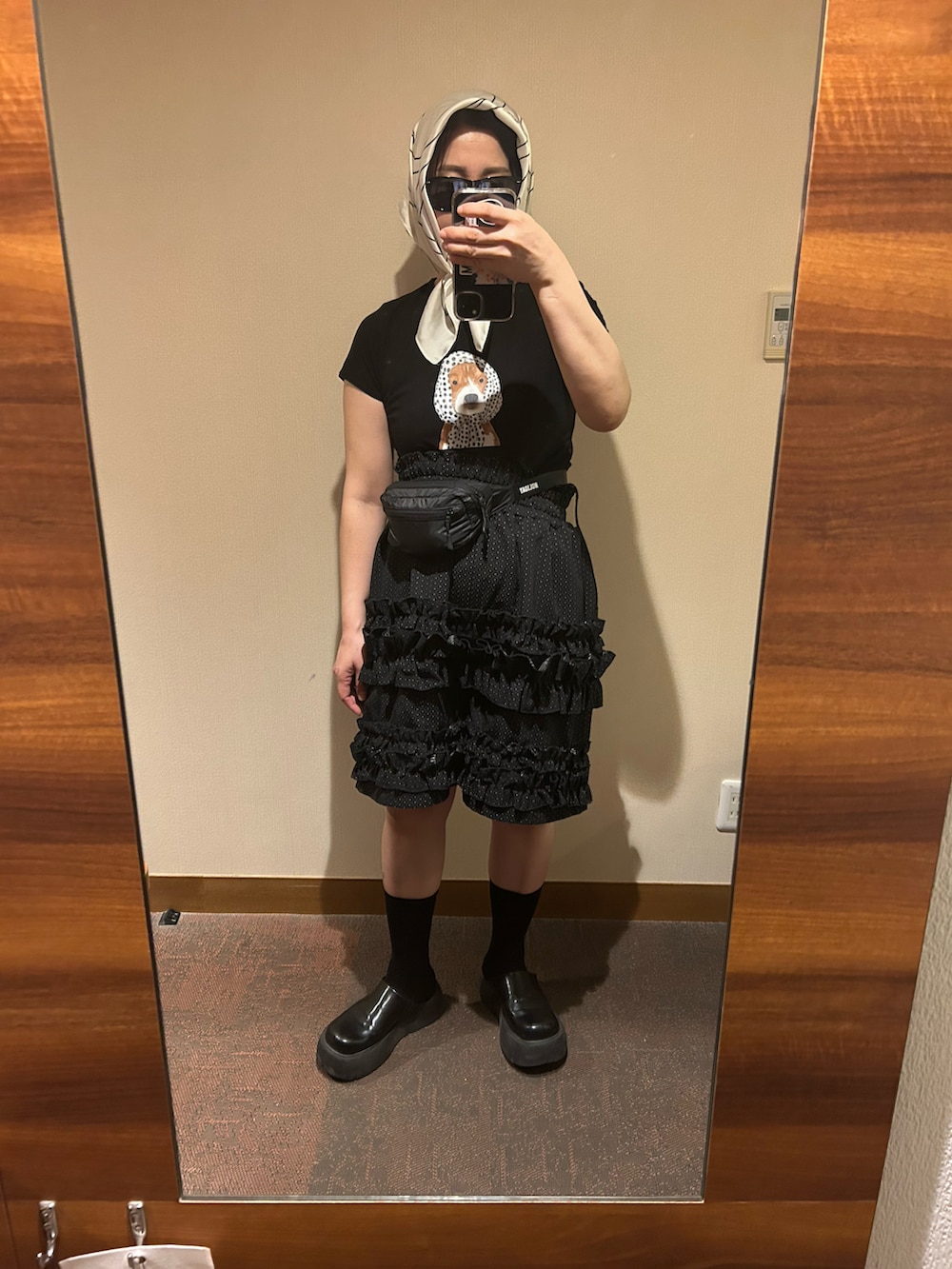 ブラック系のTシャツ/カットソー、ブラック系のその他シューズ、ブラック系のボディバッグ/ウエストポーチを着用したレディースの秋コーディネートの2枚目の写真