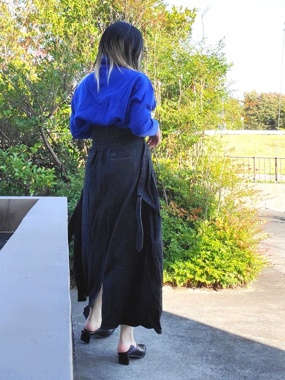 ブラック系のワンピース、ブラック系のパンプスを着用したレディースの秋コーディネートの4枚目の写真