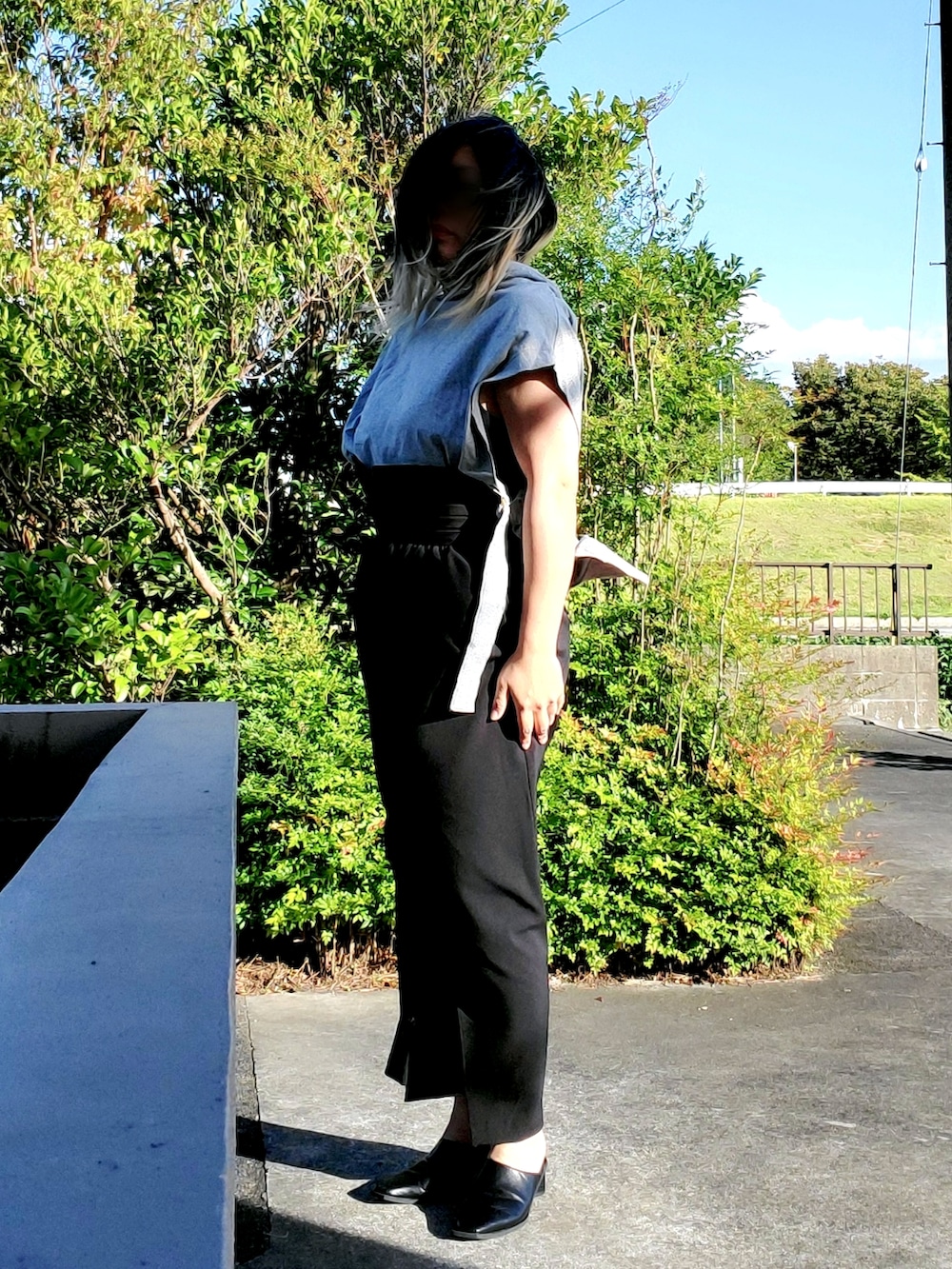 ブラック系のパンプス、ブラック系のパーカー、ブラック系のスカートを着用したレディースの秋コーディネートの4枚目の写真