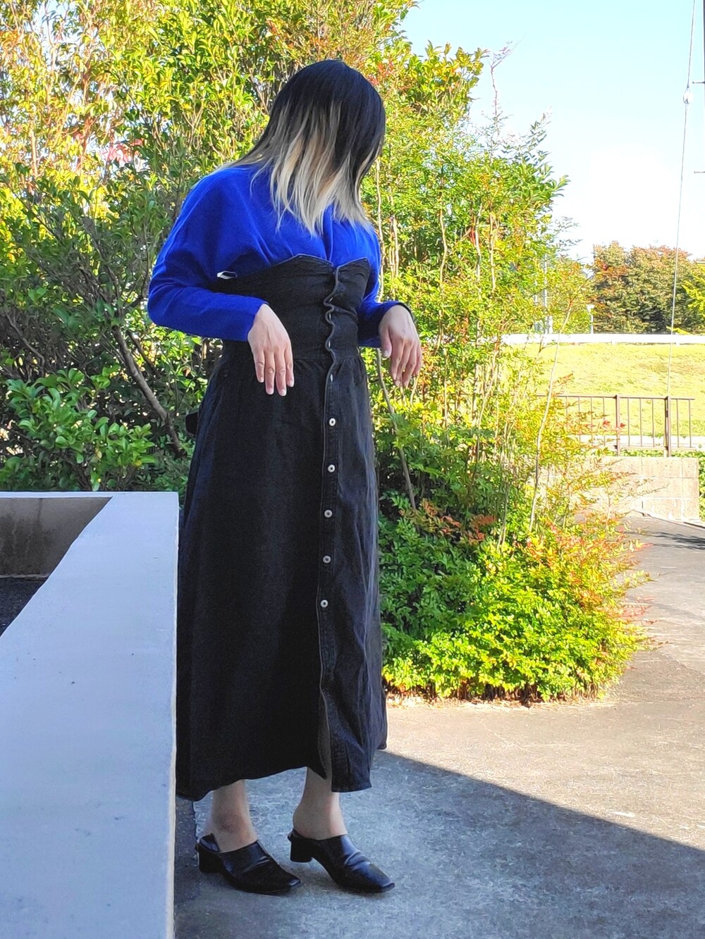 ブラック系のワンピース、ブラック系のパンプスを着用したレディースの秋コーディネートの3枚目の写真