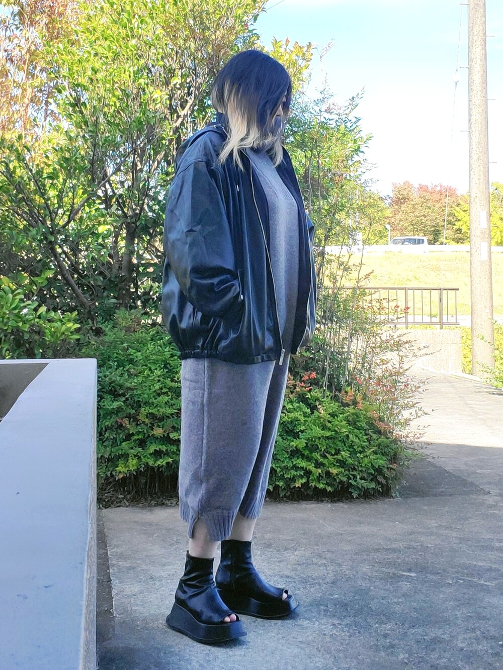 ブラック系のジャケット/アウター、グレー系のワンピース、ブラック系のスリッポンを着用したレディースの秋コーディネートの3枚目の写真