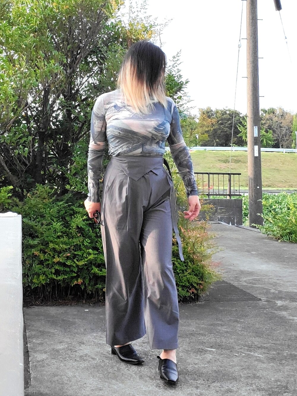 グレー系のその他パンツ、ブラック系のパンプス、ブルー系のTシャツ/カットソーを着用したレディースの秋コーディネートの2枚目の写真