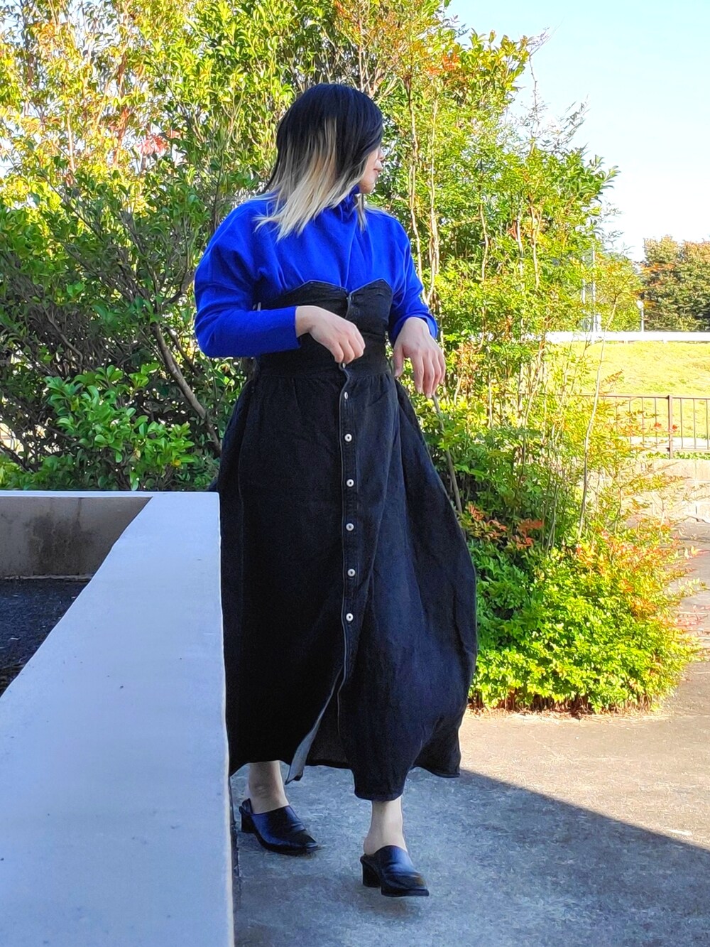 ブラック系のワンピース、ブラック系のパンプスを着用したレディースの秋コーディネートの5枚目の写真