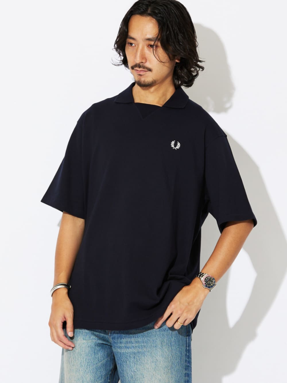 ブラック系のローファー、ブルー系のポロシャツ、ブルー系のデニムパンツを着用したメンズの夏コーディネートの4枚目の写真