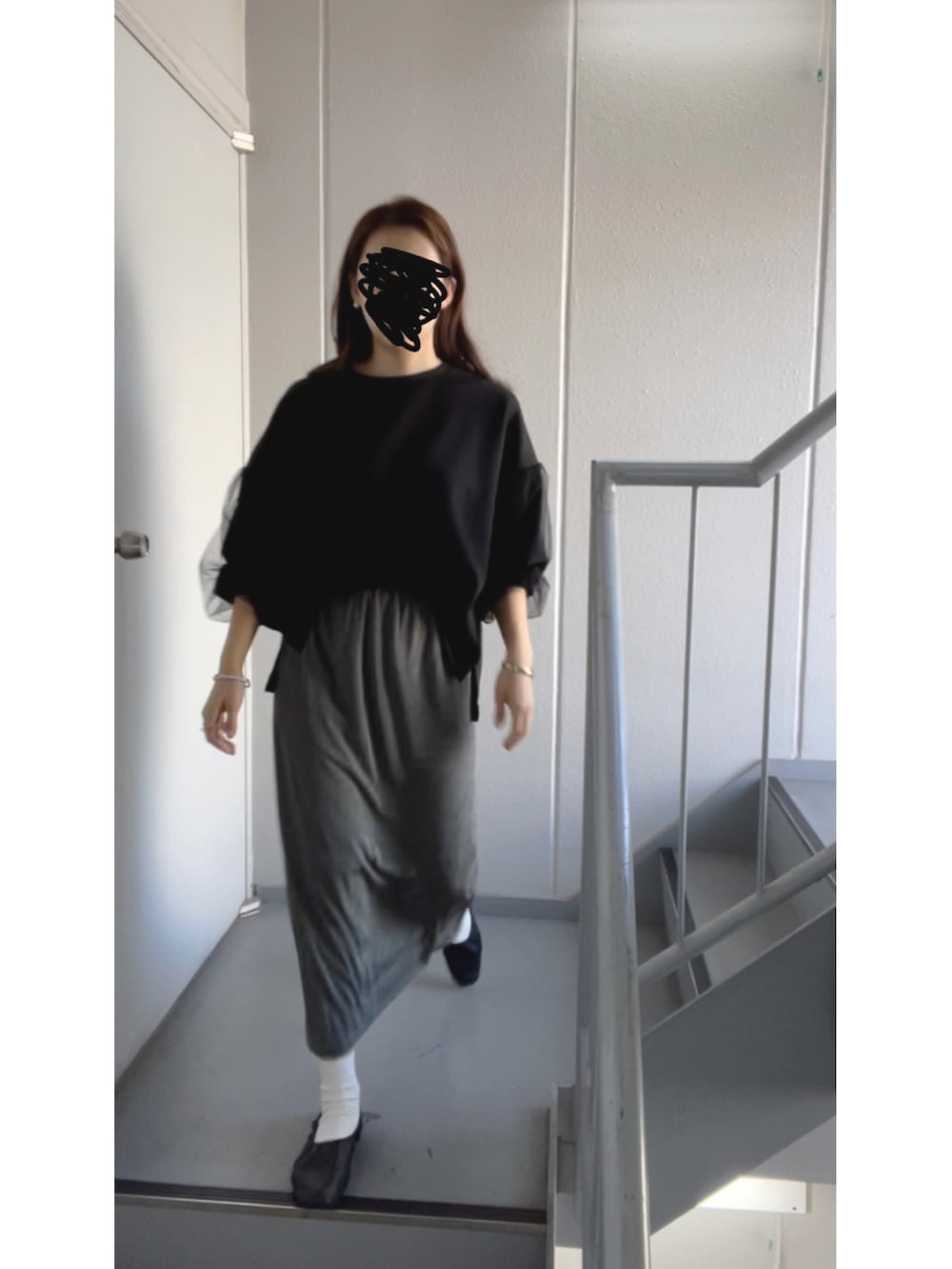 グレー系のスカートを着用したレディースの秋コーディネートの5枚目の写真