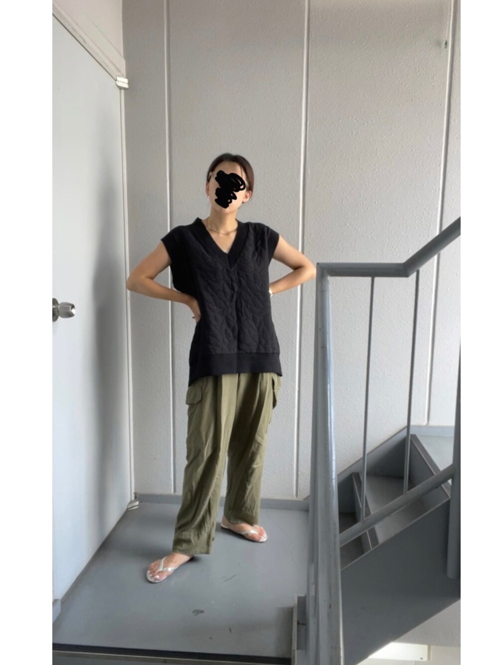 ブラック系のベスト、グリーン系のカーゴパンツ、シルバー系のサンダルを着用したレディースの夏コーディネートの3枚目の写真