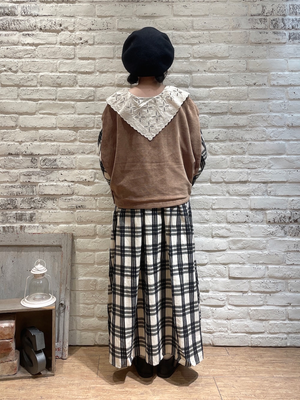 ベージュ系のベスト、ブラック系のハンドバッグ、ベージュ系のワンピースを着用したレディースの秋コーディネートの3枚目の写真