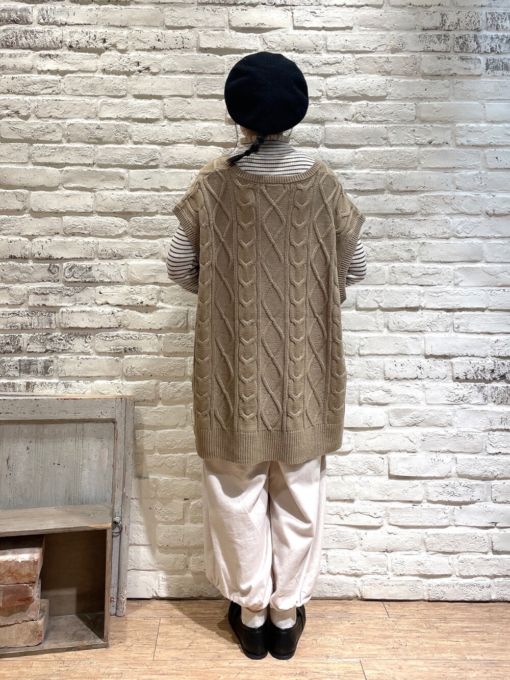 ホワイト系のニット/セーター、ベージュ系のベスト、グレー系のハンドバッグを着用したレディースの秋コーディネートの3枚目の写真