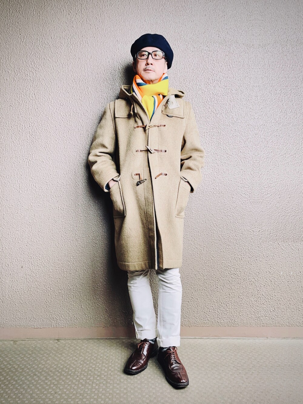 ベージュ系のダッフルコート、ブルー系のチェスターコート、ホワイト系のデニムパンツを着用したメンズの冬コーディネートの5枚目の写真