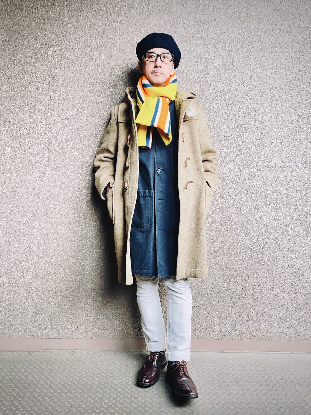 ベージュ系のダッフルコート、ブルー系のチェスターコート、ホワイト系のデニムパンツを着用したメンズの冬コーディネートの2枚目の写真