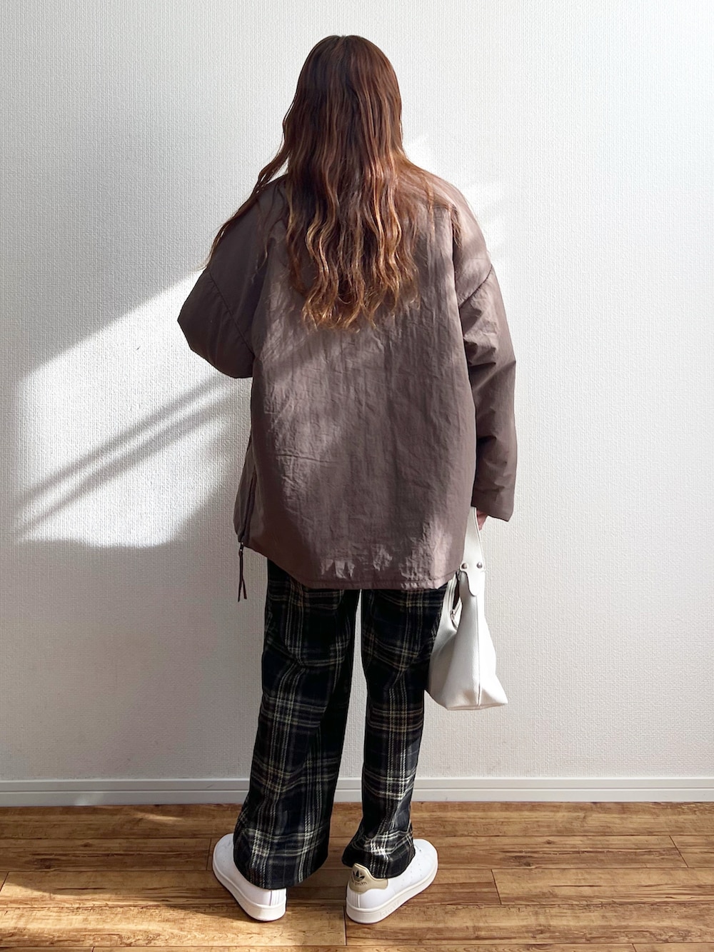 ブラウン系のその他アウター、ホワイト系のハンドバッグを着用したレディースの冬コーディネートの3枚目の写真