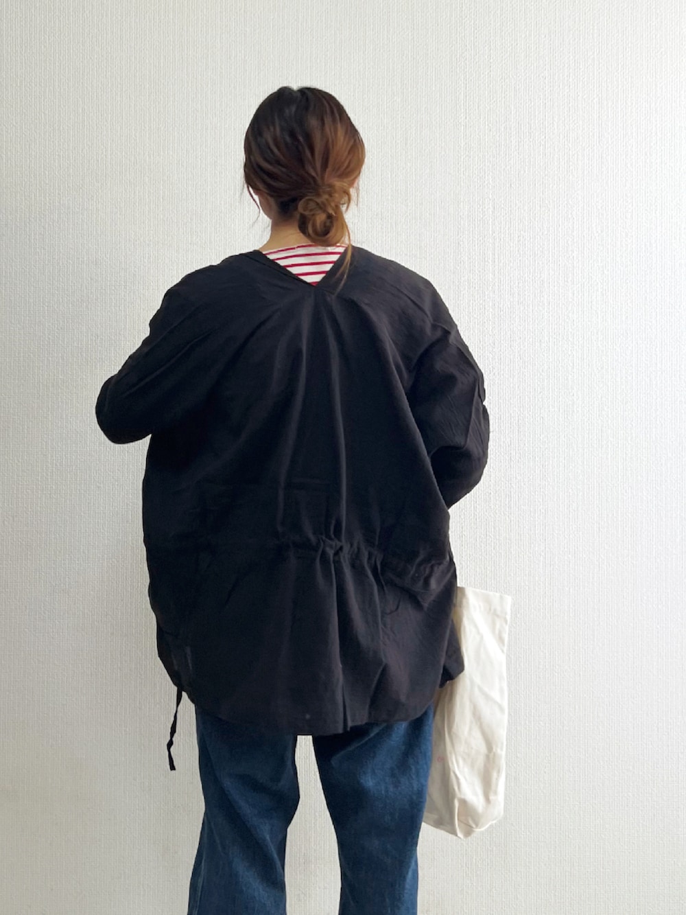 ブラック系のカーディガン/ボレロ、ブラック系のスニーカー、ブルー系のサロペット/オーバーオールを着用したレディースの春コーディネートの3枚目の写真