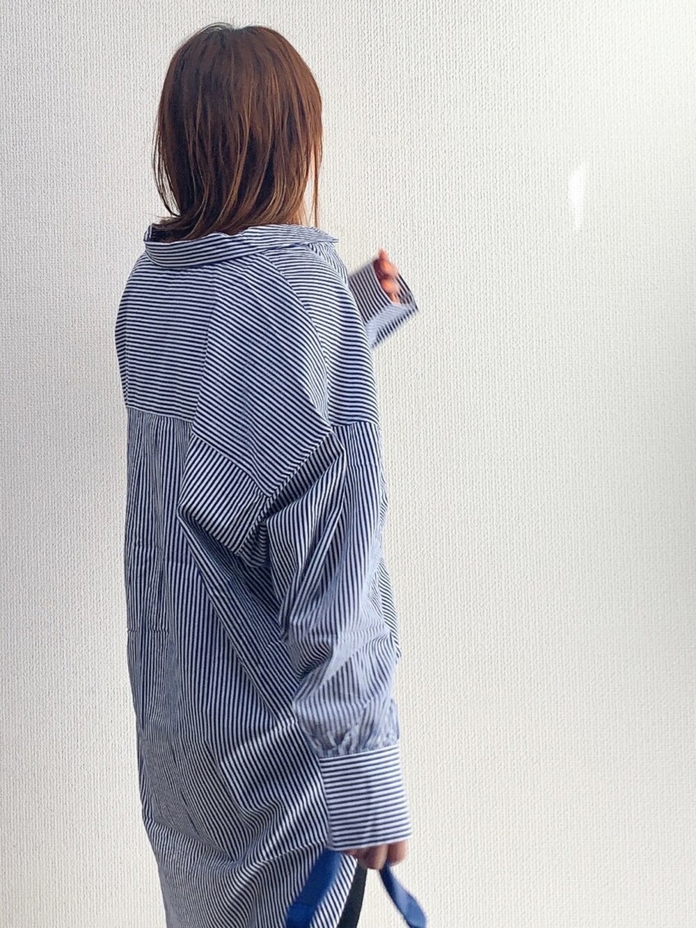 ブルー系のシャツ/ブラウス、ブラック系のスウェットパンツ、ブルー系のショルダーバッグを着用したレディースの春コーディネートの2枚目の写真
