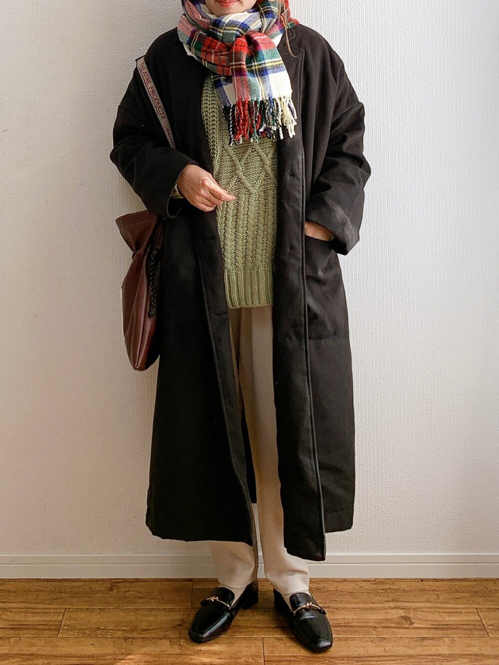 グリーン系のニット/セーター、ブラック系のローファー、ホワイト系のその他パンツを着用したレディースの秋コーディネートの2枚目の写真