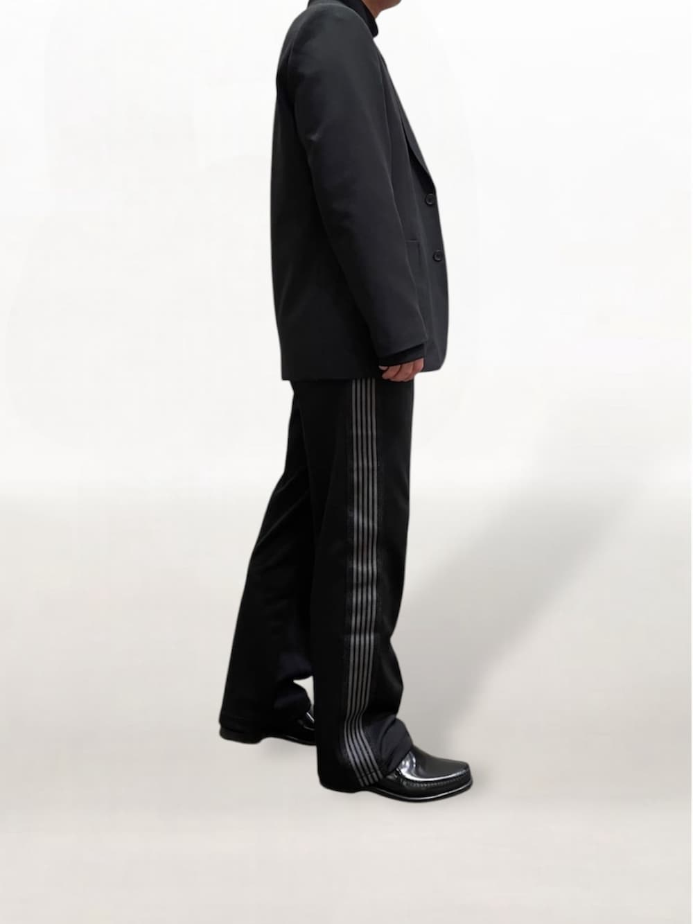 ブラック系のローファー、ブラック系のその他パンツ、ブラック系のテーラードジャケットを着用したメンズの冬コーディネートの4枚目の写真