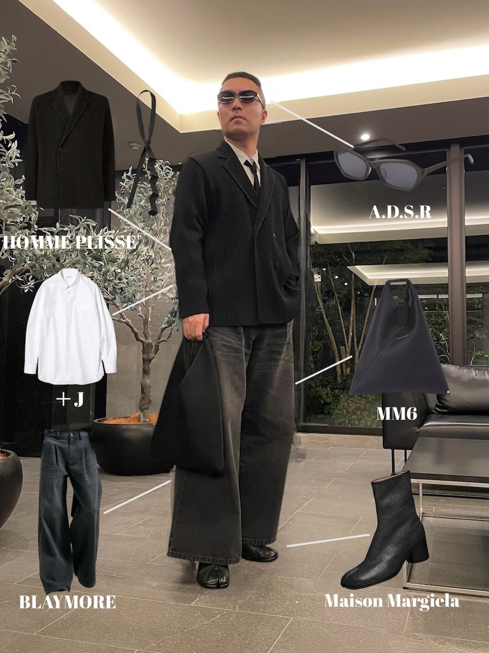 ブラック系のデニムパンツ、ブラック系のトートバッグ、ブラック系のブーツを着用したメンズの春コーディネートの2枚目の写真