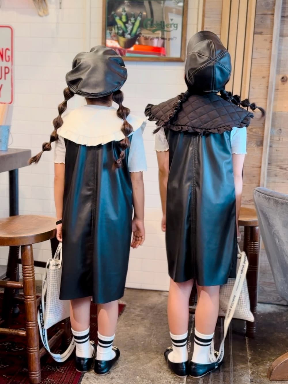 ホワイト系のTシャツ/カットソー、ブラック系のワンピース、ブラック系のパンプスを着用したキッズの秋コーディネートの3枚目の写真