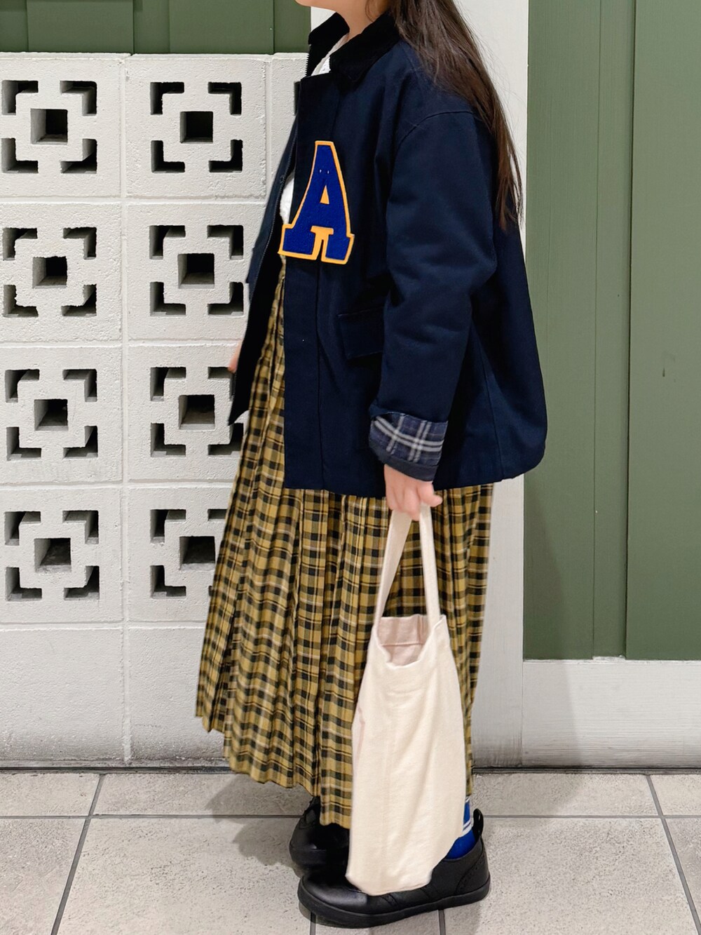 ブルー系のブルゾン、ホワイト系のシャツ/ブラウス、イエロー系のスカートを着用したキッズの秋コーディネートの2枚目の写真