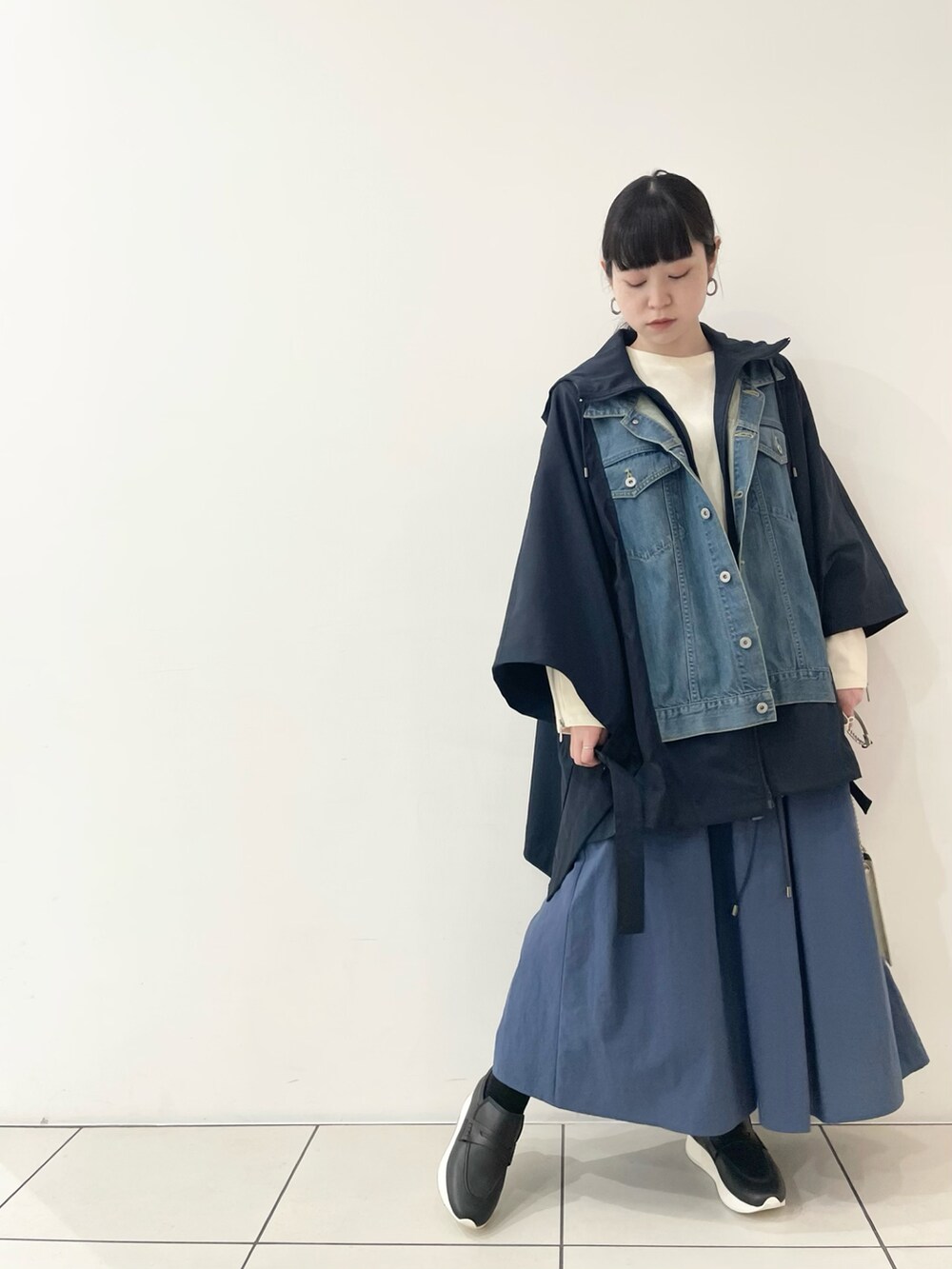 「お出かけコーデ、きれいめカジュアル、大人コーデ、レイヤードスタイル、ビッグシルエット、ボリューム袖、厚底シューズ、ブルー、ポンチョ、ミニバッグ、ショルダーバッグ、チェーンバッグ、ローファー、ロングスカート、B2nd」｜「DROIT BELLOのDROIT BELLO(ドロイトベロ)別注メタルスタッズ付きバック（ショルダーバッグ、ホワイト系）」を使った、ISAさん（レディース・160cm）の春コーディネートの2枚目の写真