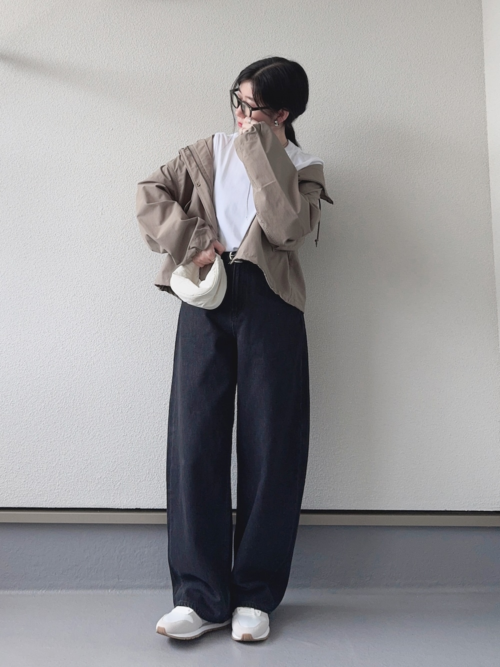 ホワイト系のTシャツ/カットソー、グリーン系のマウンテンパーカー、グレー系のデニムパンツを着用したレディースの秋コーディネートの4枚目の写真