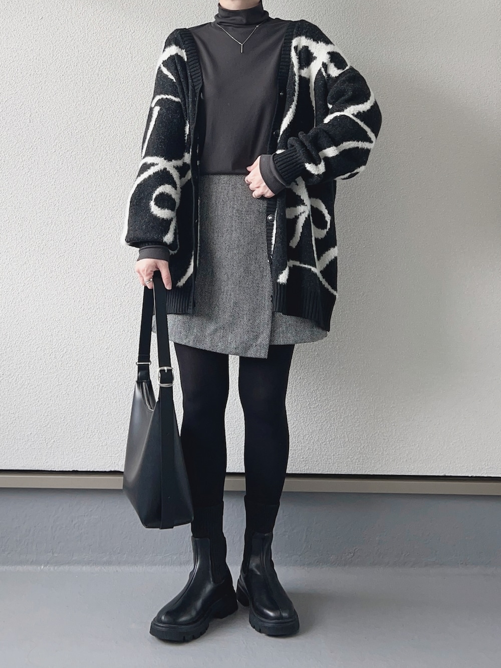 ブラック系のカーディガン/ボレロ、グレー系のTシャツ/カットソー、グレー系のスカートを着用したレディースの秋コーディネートの3枚目の写真