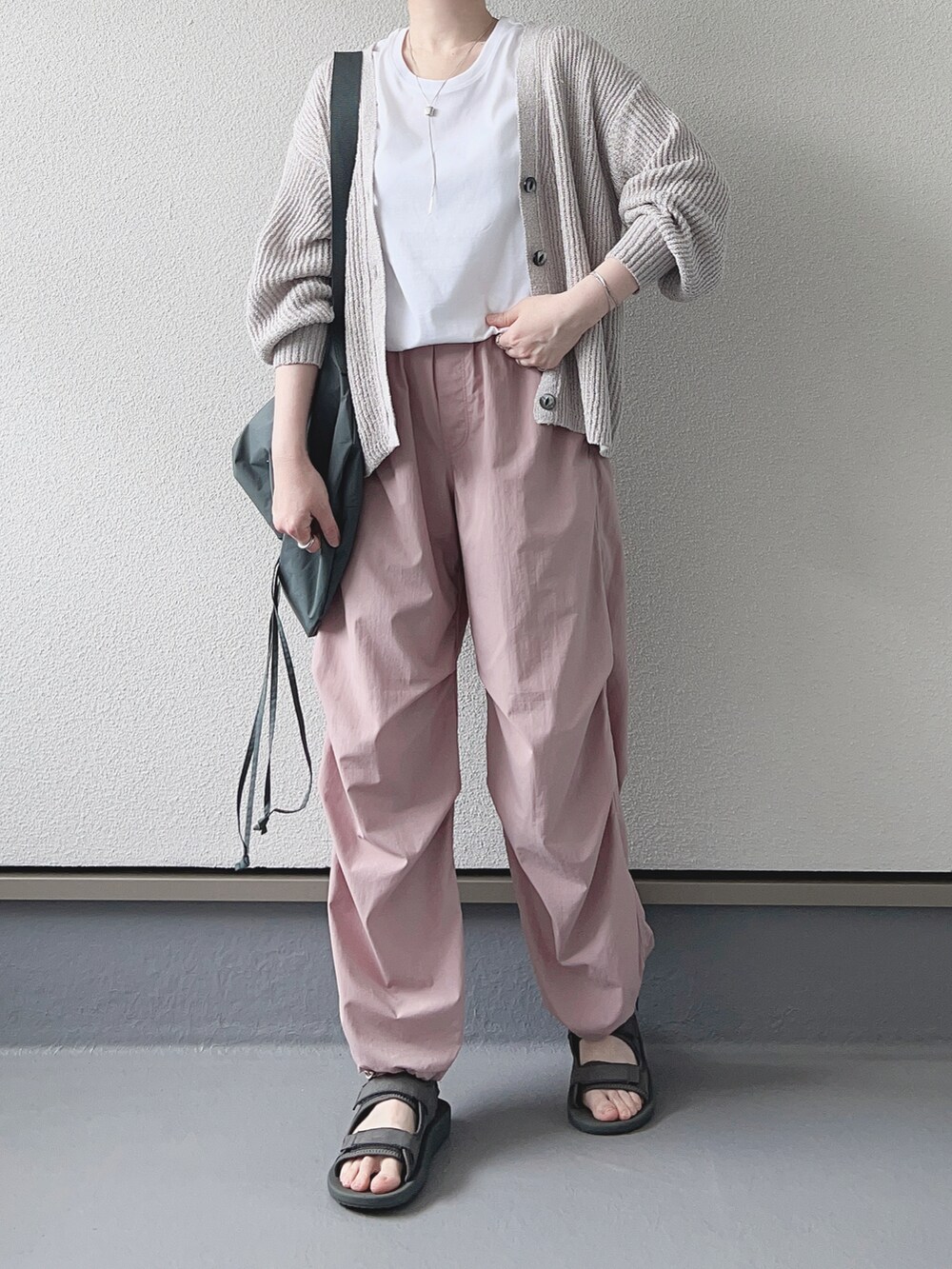 グレー系のカーディガン/ボレロ、ホワイト系のTシャツ/カットソー、ピンク系のパンツを着用したレディースの春コーディネートの3枚目の写真