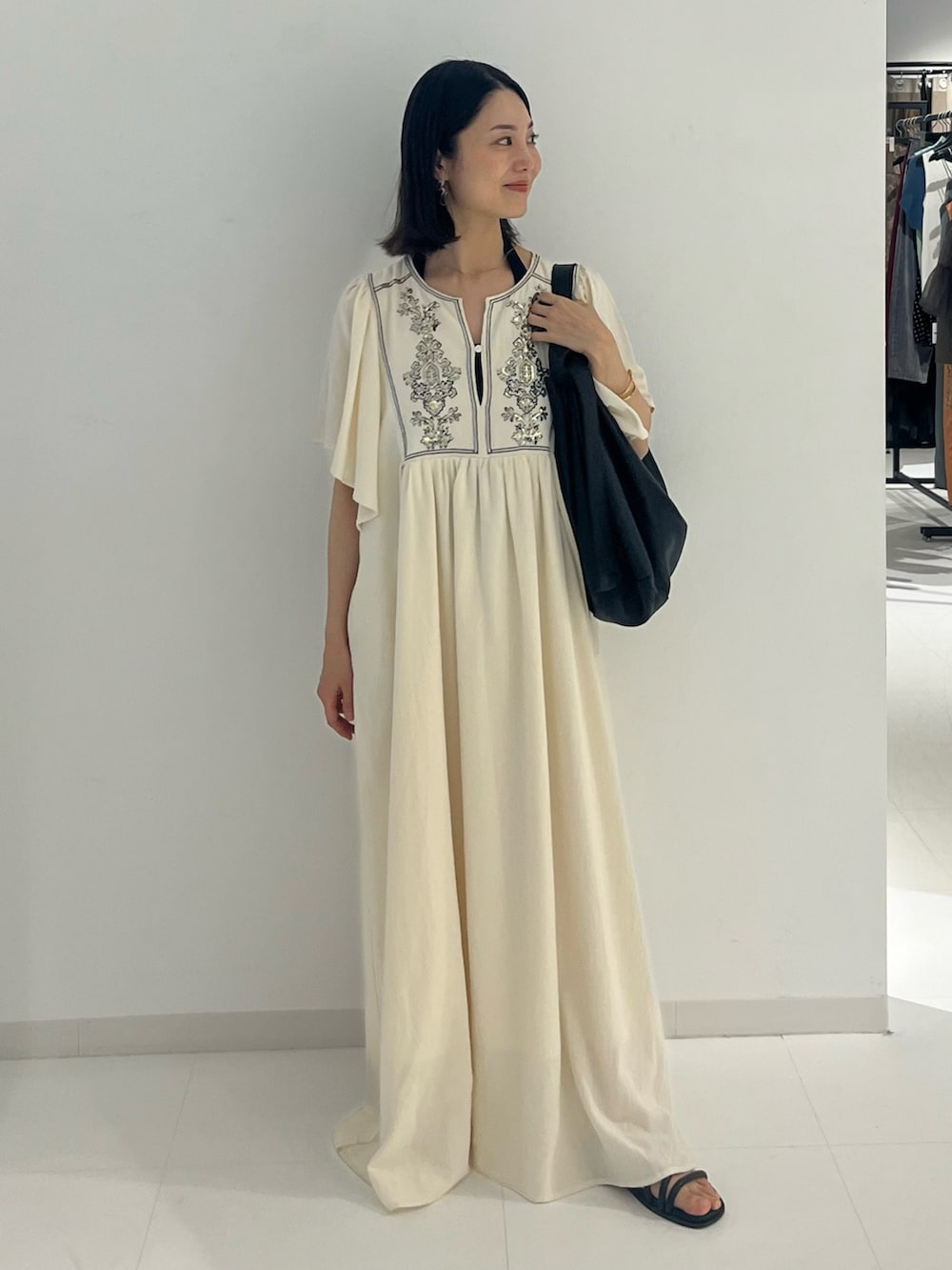 ホワイト系のワンピースを着用したレディースの夏コーディネートの2枚目の写真