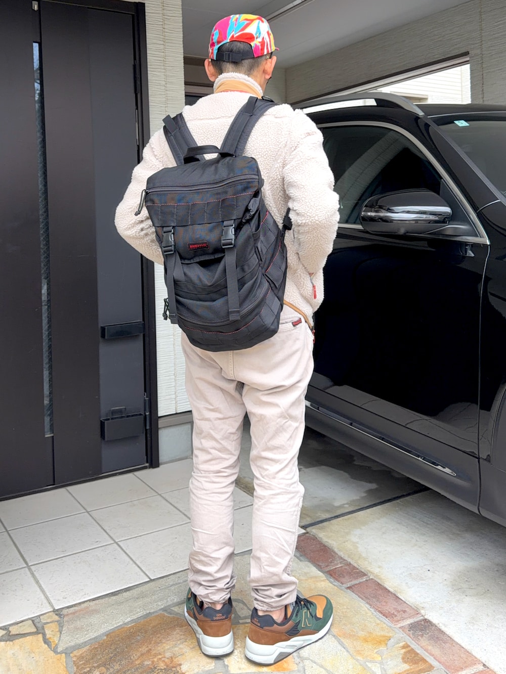 グレー系のTシャツ/カットソー、ホワイト系のブルゾン、ベージュ系のパンツを着用したメンズの春コーディネートの2枚目の写真