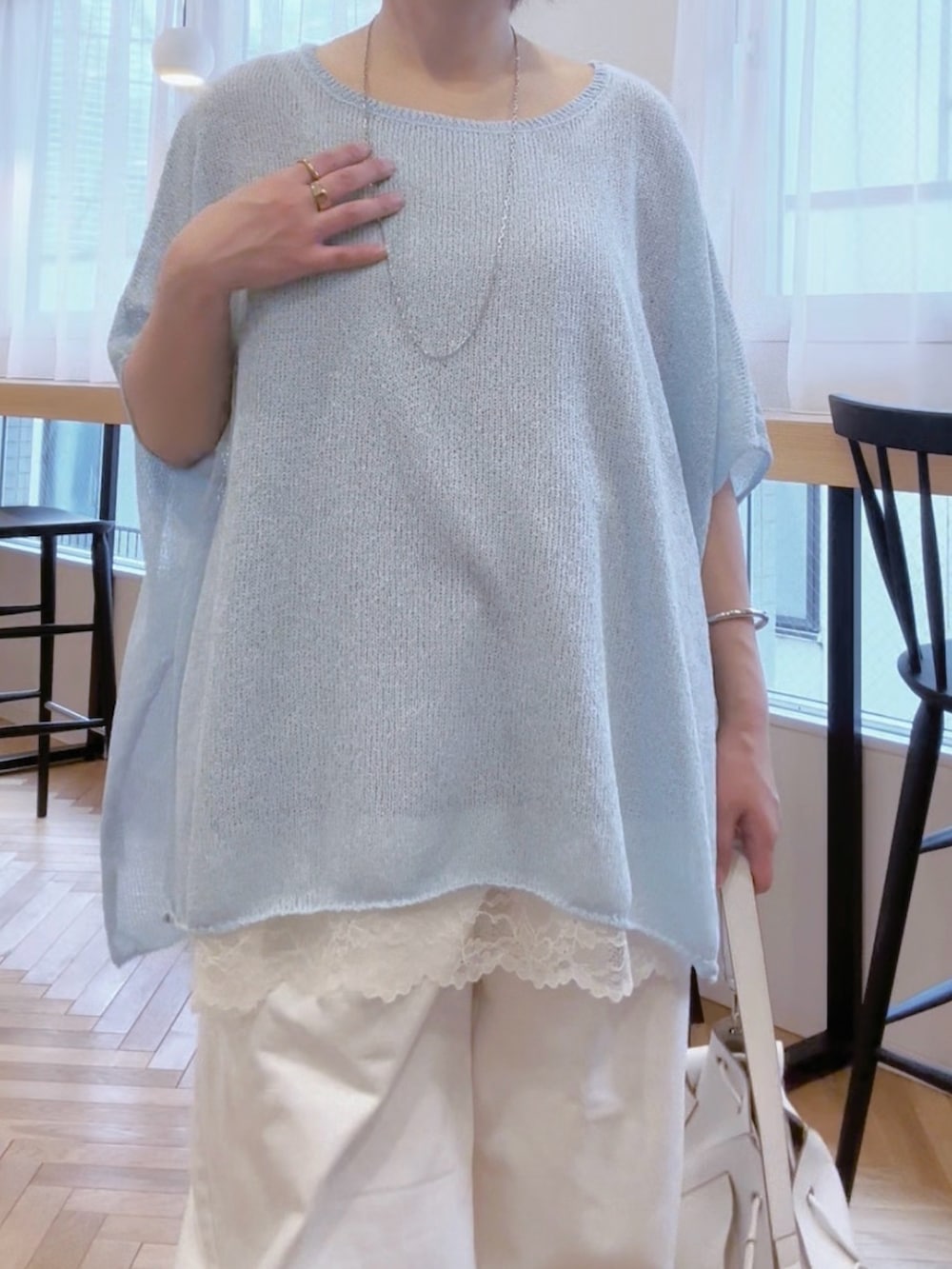 ホワイト系のデニムパンツ、ホワイト系のショルダーバッグ、ブルー系のニット/セーターを着用したレディースの春コーディネートの6枚目の写真