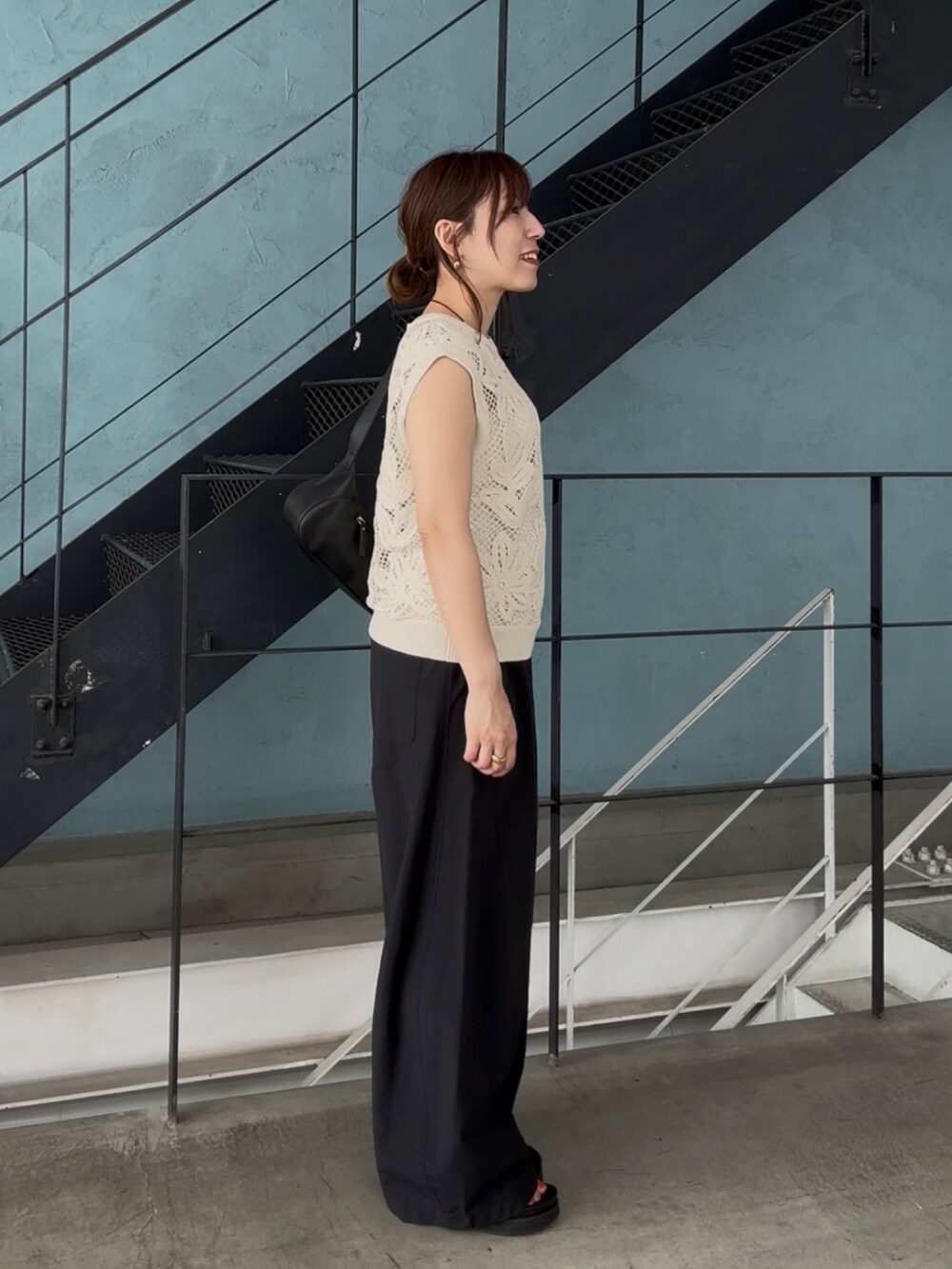 ブラック系のその他パンツ、ブラック系のサンダル、ベージュ系のニット/セーターを着用したレディースの夏コーディネートの3枚目の写真