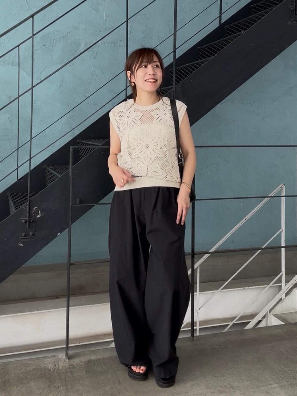 ブラック系のその他パンツ、ブラック系のサンダル、ベージュ系のニット/セーターを着用したレディースの夏コーディネートの7枚目の写真