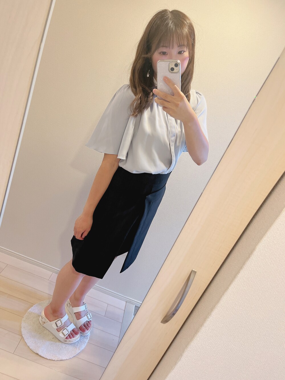 ブルー系のシャツ/ブラウス、ブラック系のスカートを着用したレディースの夏コーディネートの2枚目の写真