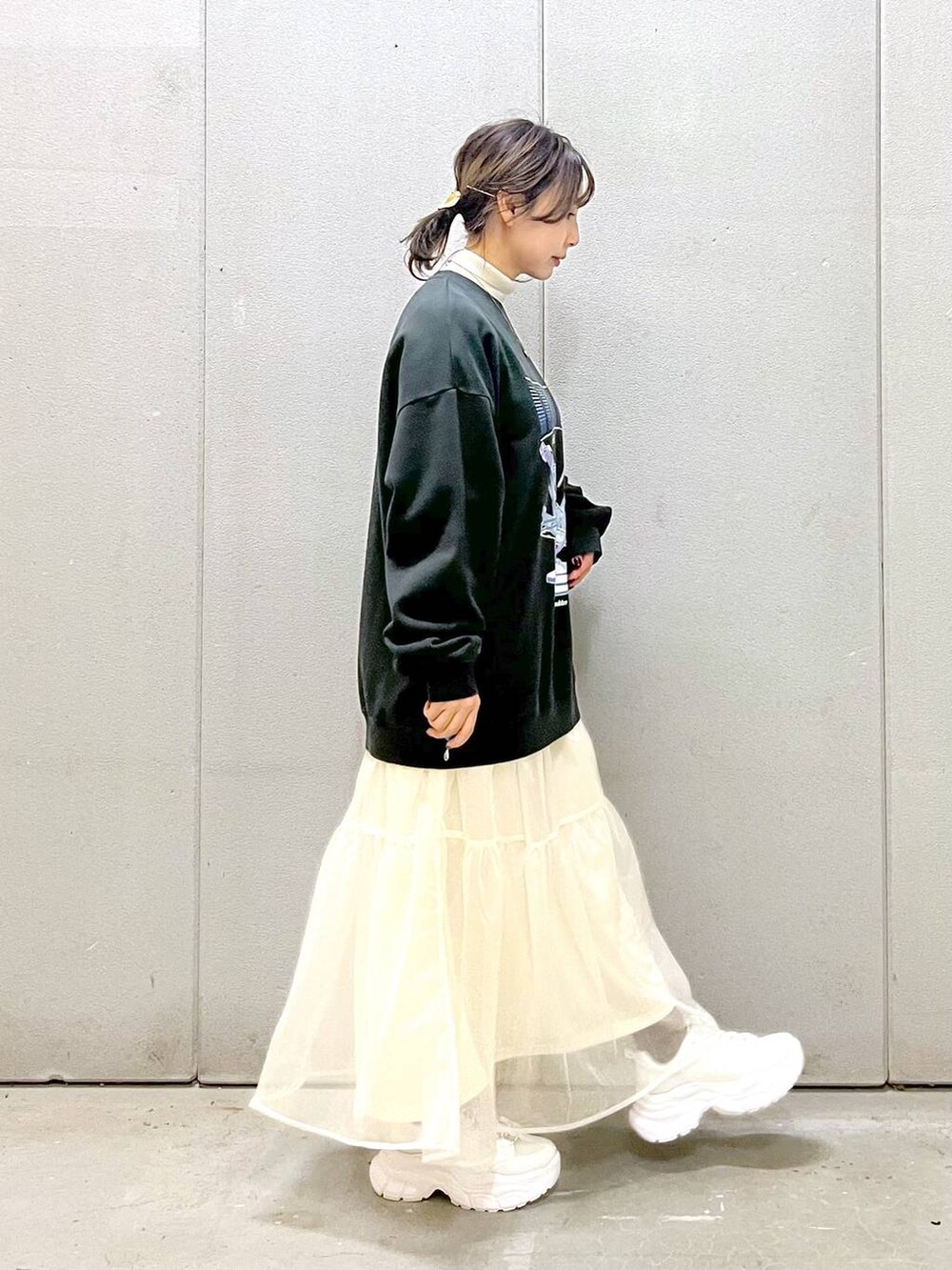 ホワイト系のニット/セーター、ホワイト系のスカート、ホワイト系のスニーカーを着用したレディースの秋コーディネートの5枚目の写真