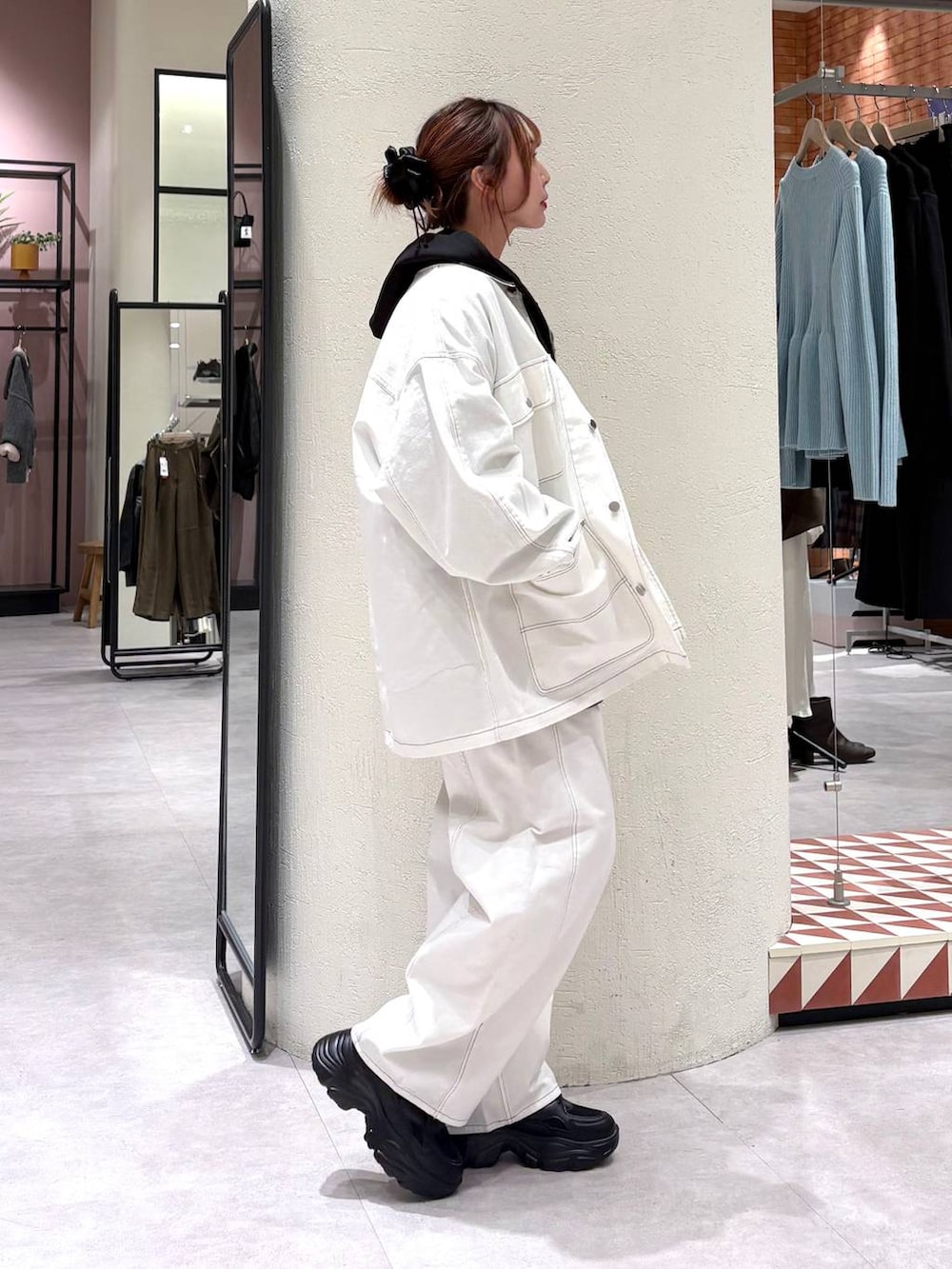 ブラック系のパーカー、ホワイト系のデニムパンツ、ホワイト系のデニムジャケットを着用したレディースの冬コーディネートの4枚目の写真