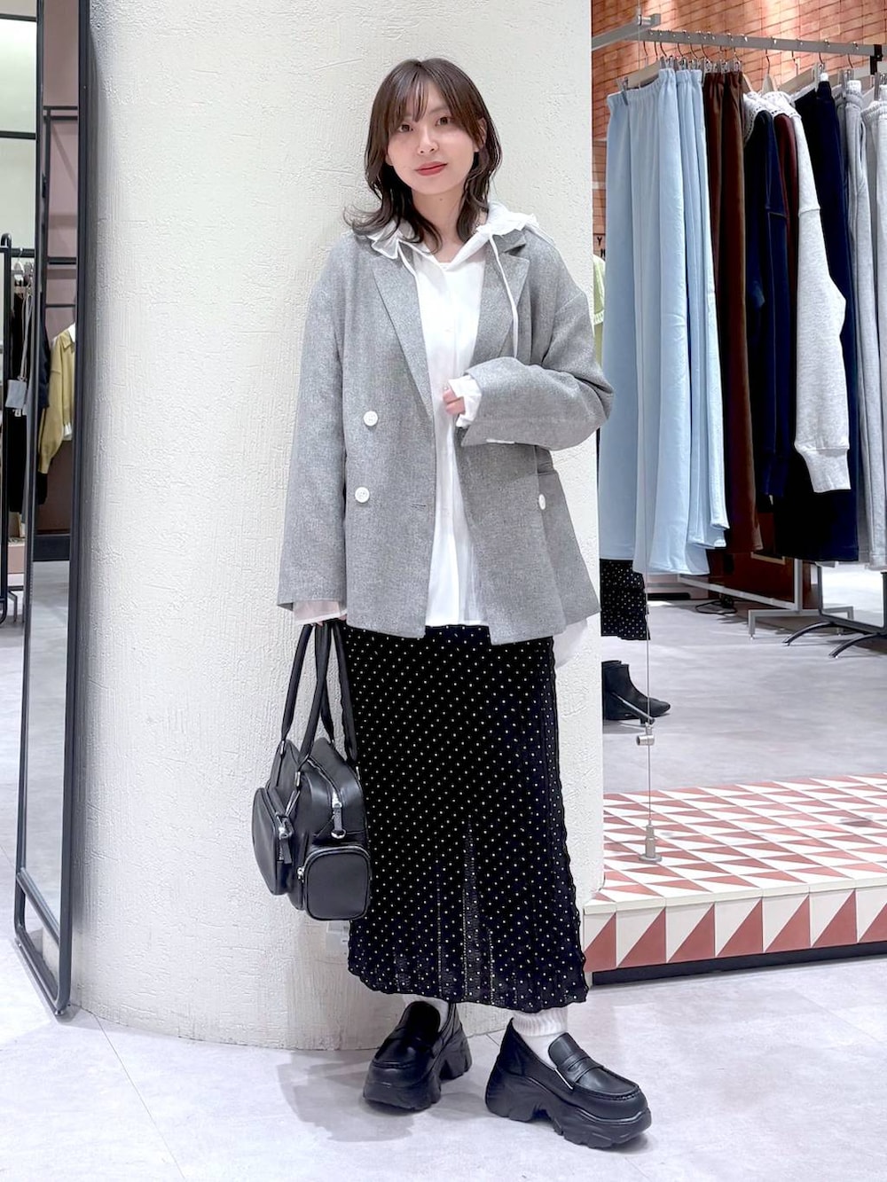 ホワイト系のシャツ/ブラウス、グレー系のテーラードジャケット、ブラック系のボストンバッグを着用したレディースの冬コーディネートの5枚目の写真