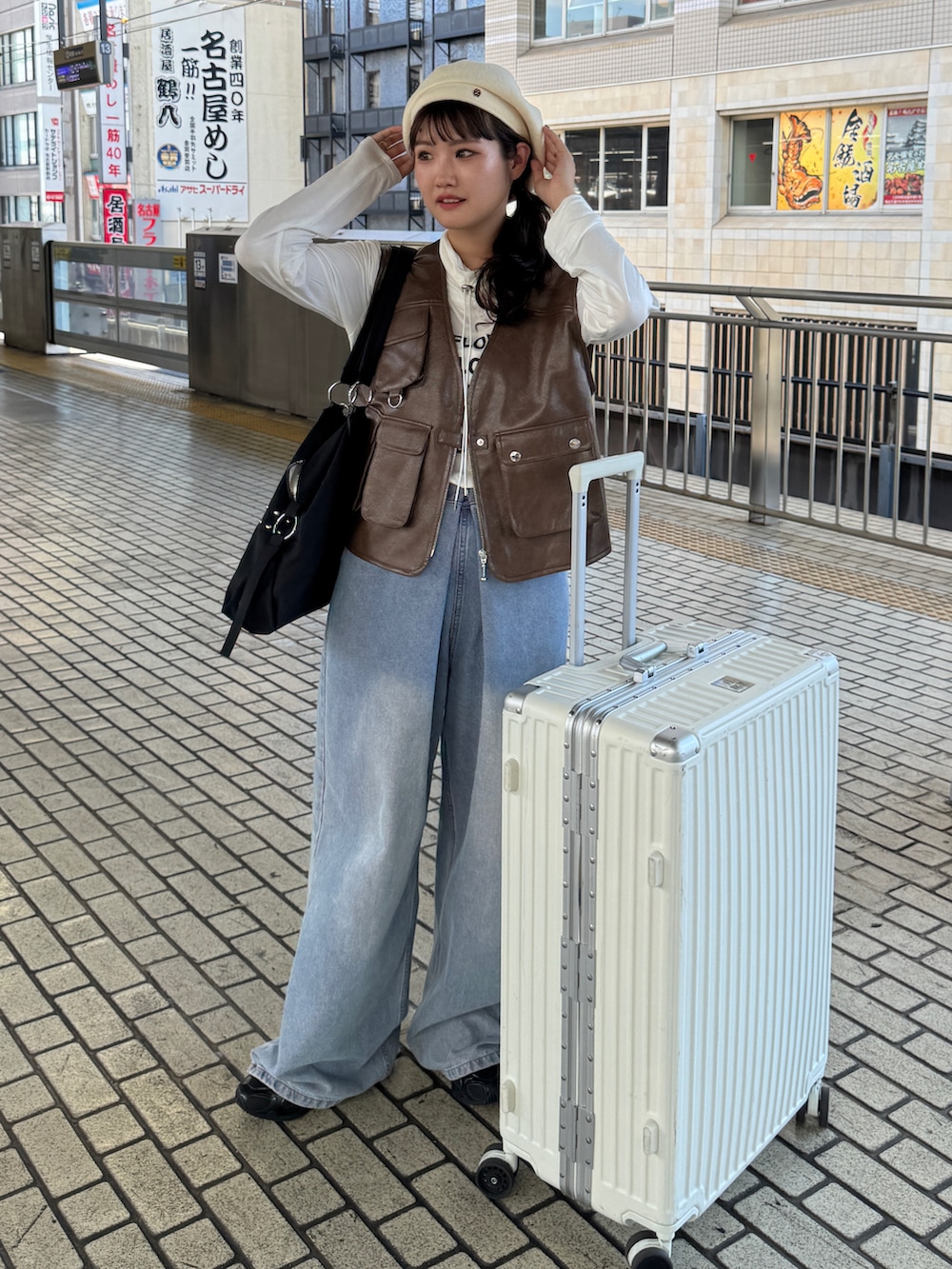 ホワイト系のTシャツ/カットソー、ブルー系のデニムパンツ、ブラック系のトートバッグを着用したレディースの秋コーディネートの2枚目の写真