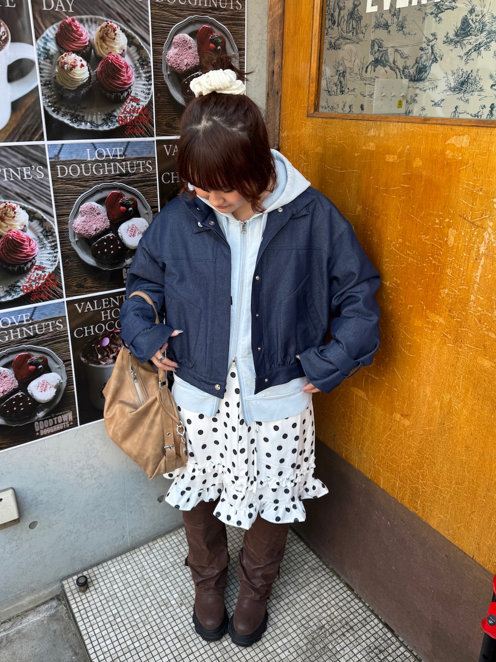 ブルー系のパーカー、ブラウン系のブーツ、ホワイト系のスカートを着用したレディースの冬コーディネートの2枚目の写真