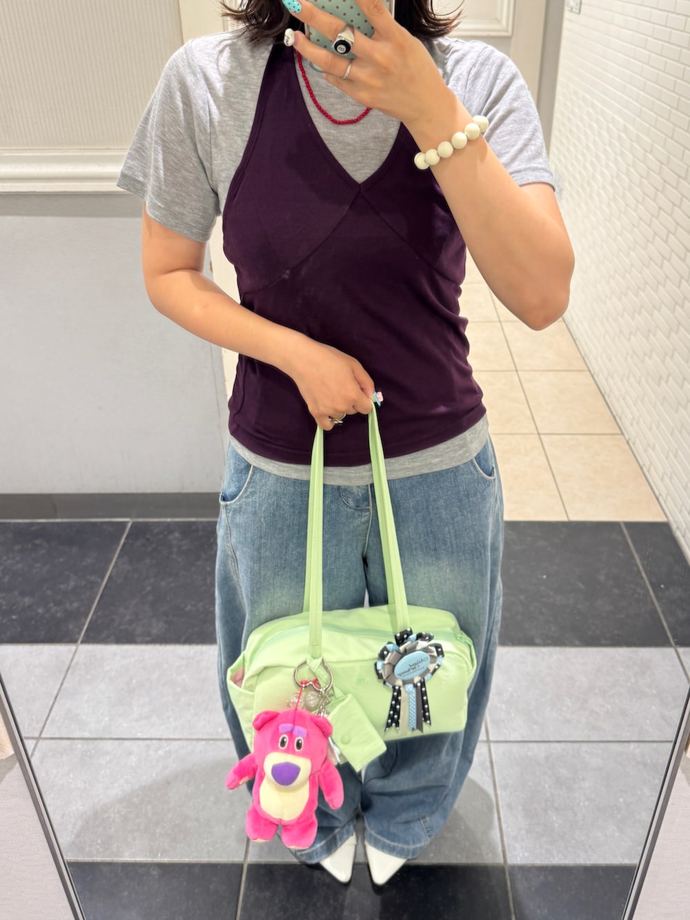 グレー系のTシャツ/カットソー、ブルー系のデニムパンツ、ホワイト系のパンプスを着用したレディースの夏コーディネートの2枚目の写真