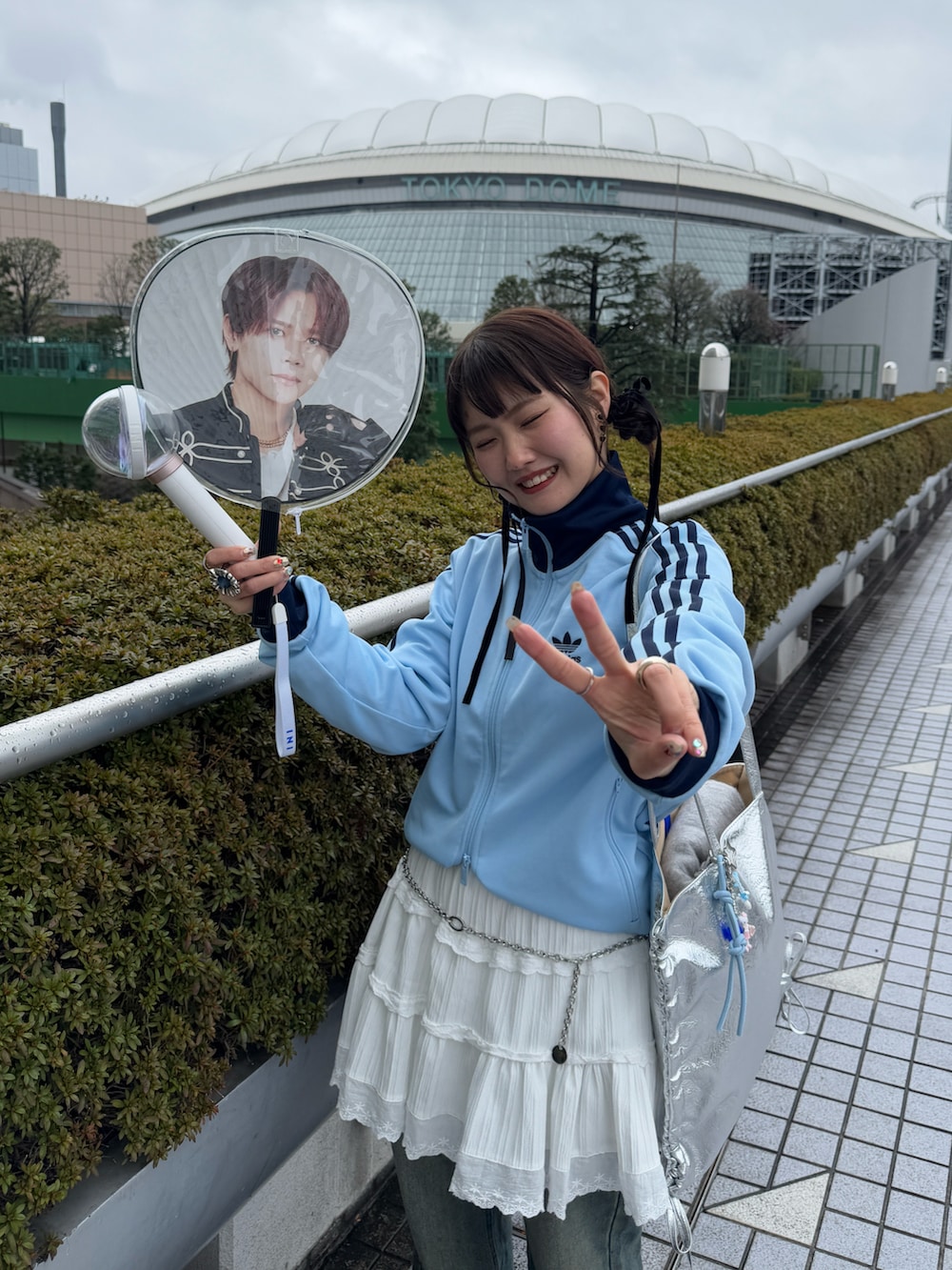 ブルー系のジャージ、ホワイト系のスカート、ブルー系のデニムパンツを着用したレディースの冬コーディネートの2枚目の写真