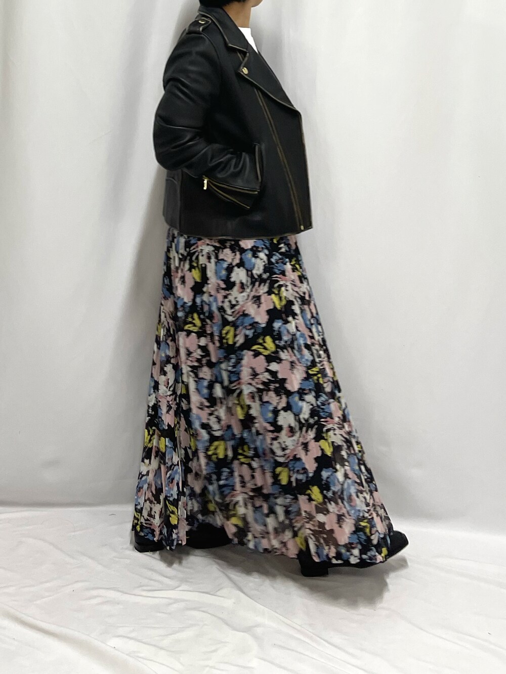 ホワイト系のTシャツ/カットソー、ブラック系のライダースジャケット、ブルー系のスカートを着用したレディースの夏コーディネートの2枚目の写真