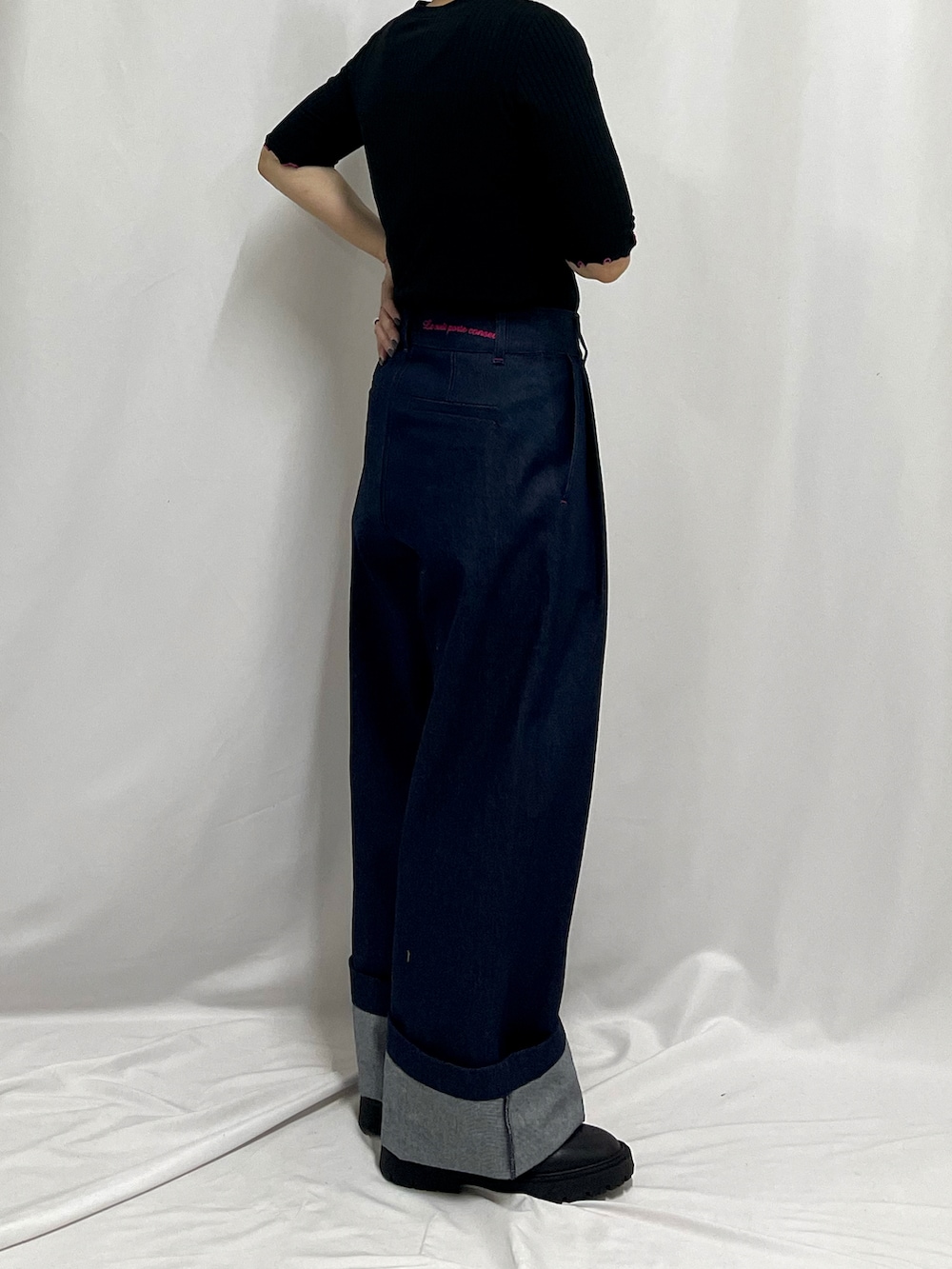 ブラック系のブーツ、ブルー系のデニムパンツ、ブラック系のTシャツ/カットソーを着用したレディースの秋コーディネートの2枚目の写真