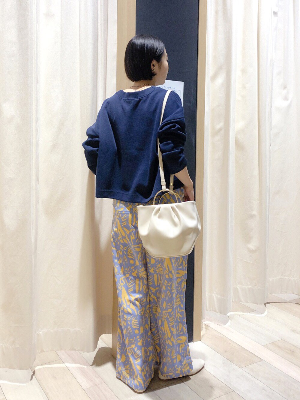 ホワイト系のハンドバッグ、ブルー系のカーディガン/ボレロ、ブルー系のその他パンツを着用したレディースの春コーディネートの4枚目の写真