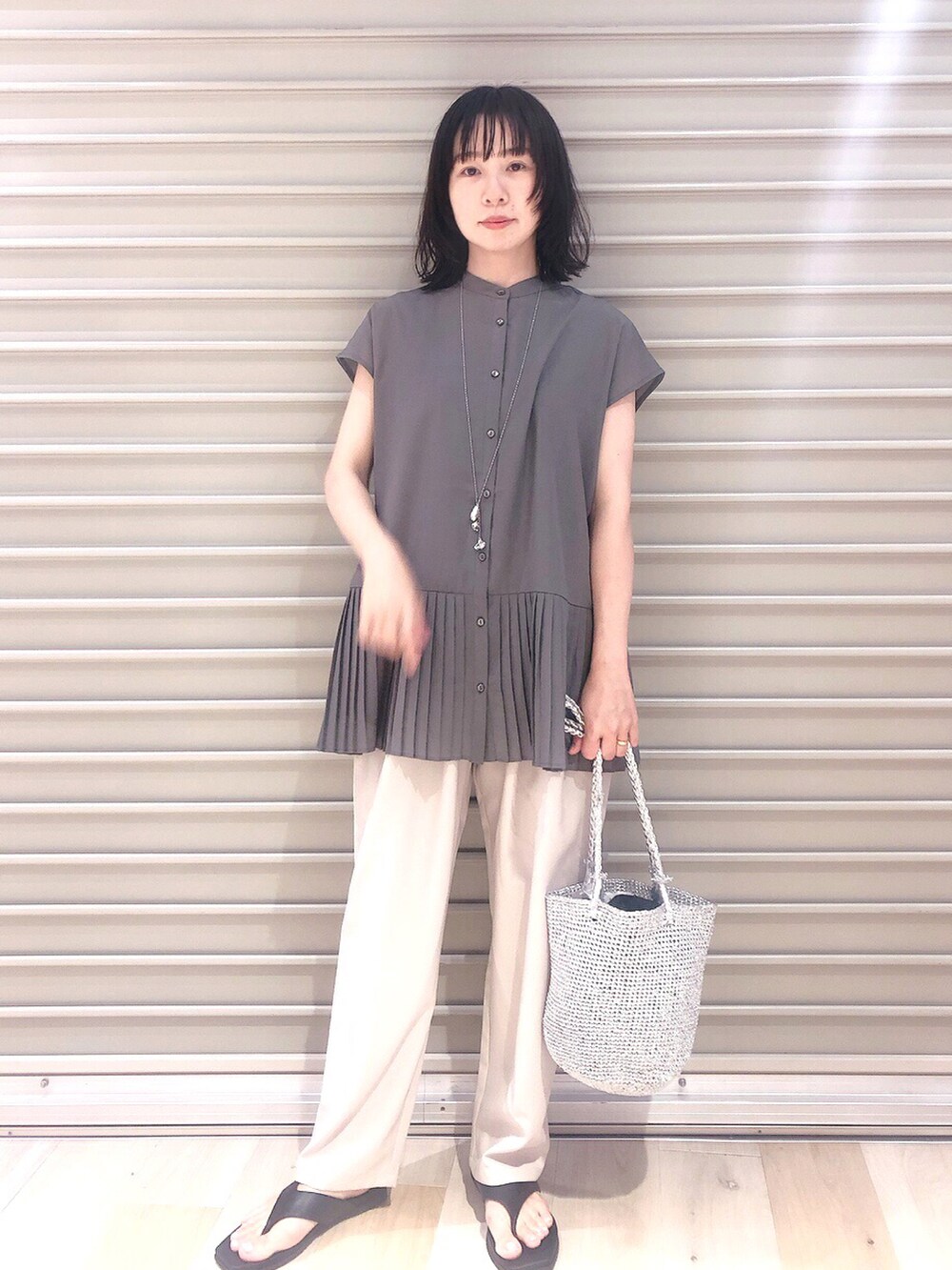 グレー系のシャツ/ブラウス、ベージュ系のその他パンツ、シルバー系のショルダーバッグを着用したレディースの夏コーディネートの3枚目の写真
