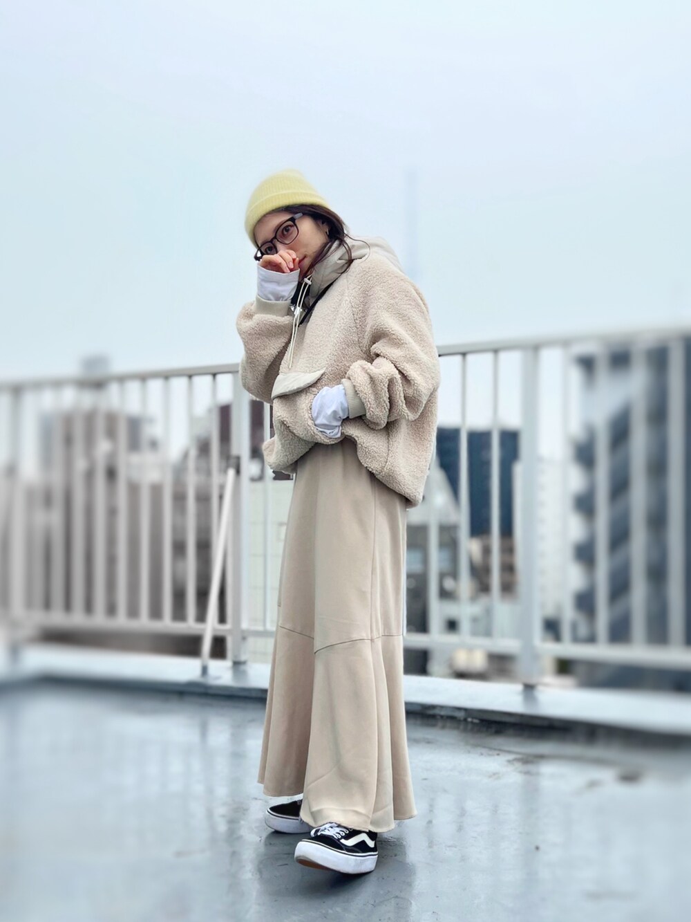 ブラック系のスニーカー、ベージュ系のワンピース、ベージュ系のパーカーを着用したレディースの冬コーディネートの2枚目の写真