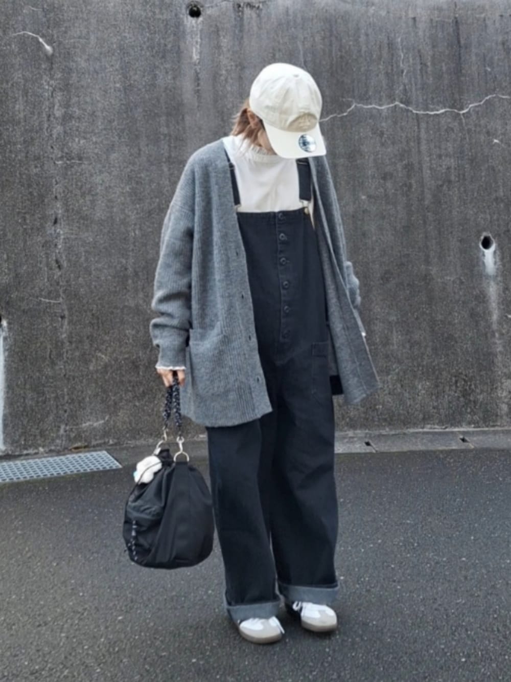 ホワイト系のシャツ/ブラウス、ブルー系のサロペット/オーバーオール、ブラック系のショルダーバッグを着用したレディースの冬コーディネートの2枚目の写真