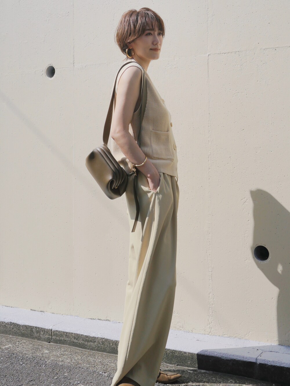 グリーン系のその他パンツ、グリーン系のショルダーバッグ、ホワイト系のカーディガン/ボレロを着用したレディースの秋コーディネートの3枚目の写真