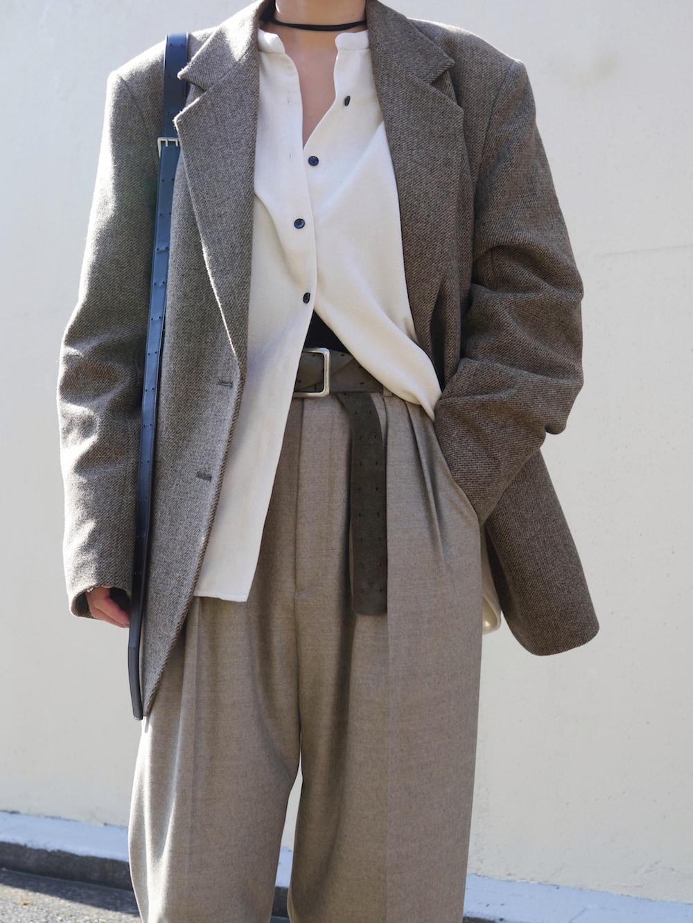 ベージュ系のテーラードジャケット、ベージュ系のその他パンツ、ブラック系のショルダーバッグを着用したレディースの秋コーディネートの2枚目の写真