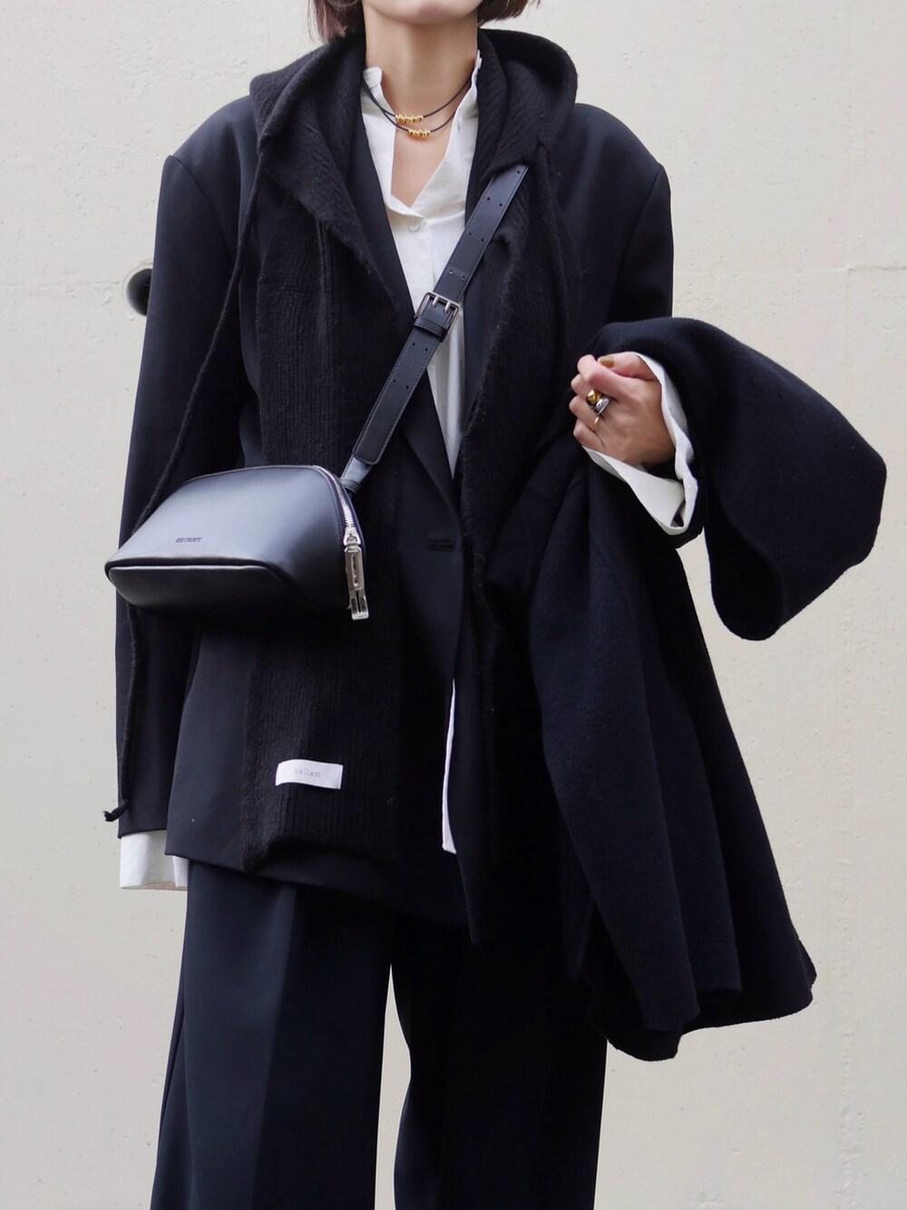 ブラック系のテーラードジャケット、ブラック系のその他パンツ、ブラック系のショルダーバッグを着用したレディースの冬コーディネートの2枚目の写真