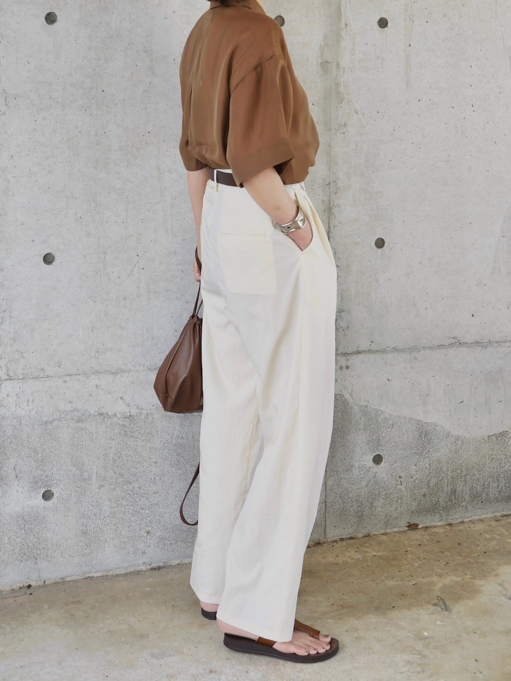 ブラウン系のシャツ/ブラウス、ホワイト系のスラックス、ブラウン系のショルダーバッグを着用したレディースの夏コーディネートの3枚目の写真